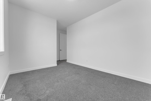 Spare room with dark carpet and baseboards - 159 Graybriar Dr, Stony Plain, AB - Indoor Photo Showing Other Room