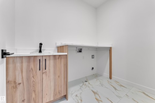 Laundry room featuring light marble finish floors and hookup for a washing machine - 159 Graybriar Dr, Stony Plain, AB - Indoor Photo Showing Other Room