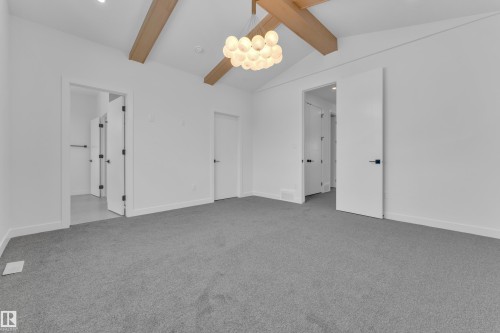 Unfurnished bedroom featuring light colored carpet, beamed ceiling, and connected bathroom - 159 Graybriar Dr, Stony Plain, AB - Indoor Photo Showing Other Room