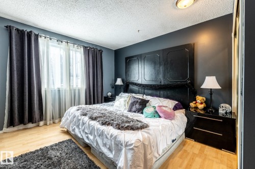 Bedroom featuring light wood-type flooring and a textured ceiling - 69 Amherst Crescent, St. Albert, AB - Indoor Photo Showing Bedroom