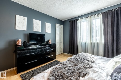 Bedroom featuring light wood-type flooring, a textured ceiling, and a closet - 69 Amherst Crescent, St. Albert, AB - Indoor Photo Showing Bedroom