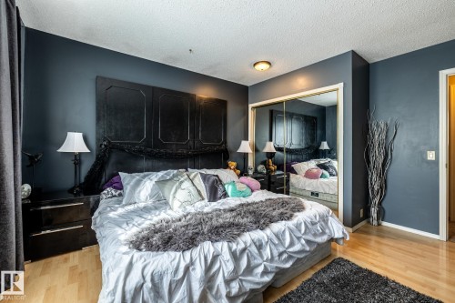 Bedroom featuring light wood-style floors, a closet, and a textured ceiling - 69 Amherst Crescent, St. Albert, AB - Indoor Photo Showing Bedroom