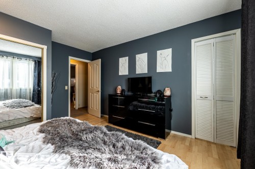 Bedroom featuring light wood-style flooring and a textured ceiling - 69 Amherst Crescent, St. Albert, AB - Indoor Photo Showing Bedroom