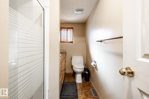 Full bathroom with a textured ceiling, vanity, and a shower stall - 69 Amherst Crescent, St. Albert, AB - Indoor Photo Showing Bathroom