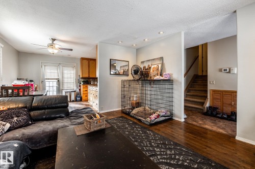 Living room with dark wood-type flooring, a ceiling fan, recessed lighting, and a textured ceiling - 69 Amherst Crescent, St. Albert, AB - Indoor Photo Showing Other Room With Fireplace