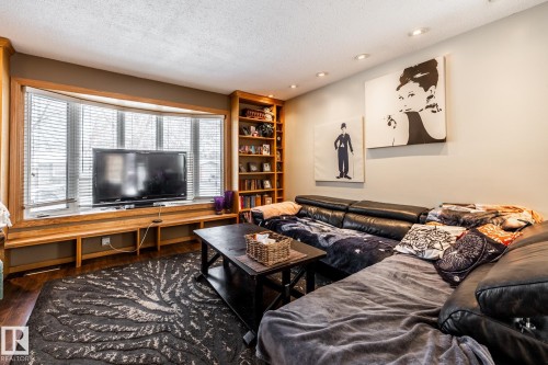 Living area featuring a textured ceiling, recessed lighting, and wood finished floors - 69 Amherst Crescent, St. Albert, AB - Indoor Photo Showing Living Room