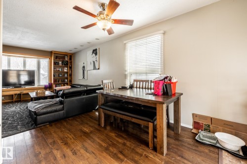 Living area featuring dark wood-style flooring, a ceiling fan, and a textured ceiling - 69 Amherst Crescent, St. Albert, AB - Indoor