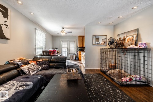 Living room with recessed lighting, a textured ceiling, a ceiling fan, and dark wood-style floors - 69 Amherst Crescent, St. Albert, AB - Indoor Photo Showing Living Room