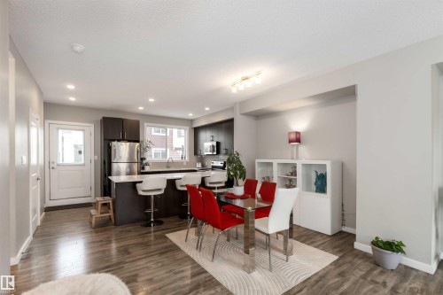 Dining space featuring dark wood-style floors, a textured ceiling, and recessed lighting - 31 2803 James Mowatt Trail, Edmonton, AB - Indoor Photo Showing Dining Room