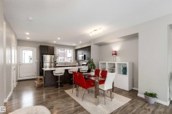 Dining space featuring dark wood-style floors, a textured ceiling, and recessed lighting - 