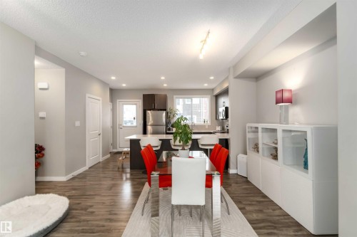 Dining space with dark wood-style floors, a textured ceiling, and recessed lighting - 31 2803 James Mowatt Trail, Edmonton, AB - Indoor Photo Showing Other Room