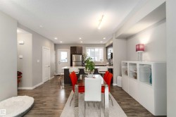 Dining space with dark wood-style floors, a textured ceiling, and recessed lighting - 