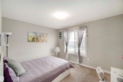 Carpeted bedroom with baseboards and a textured ceiling - 