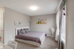 Bedroom featuring a textured ceiling and carpet flooring - 