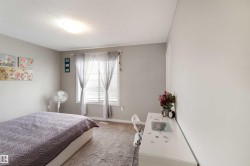 Bedroom featuring a textured ceiling and carpet - 