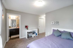Bedroom with carpet, a textured ceiling, a closet, and ensuite bath - 