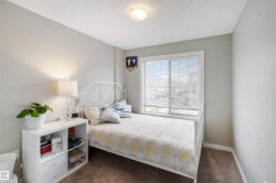 Carpeted bedroom featuring a textured ceiling and baseboards - 
