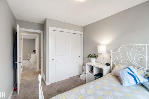 Bedroom featuring a closet and light carpet - 31 2803 James Mowatt Trail, Edmonton, AB - Indoor Photo Showing Bedroom
