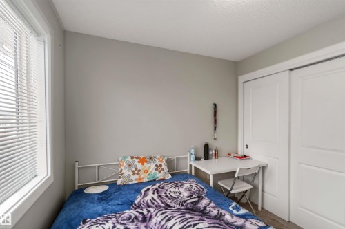 Bedroom featuring carpet floors, a closet, and a textured ceiling - 31 2803 James Mowatt Trail, Edmonton, AB - Indoor Photo Showing Bedroom