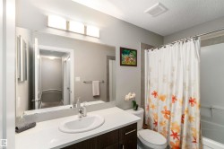 Full bathroom featuring shower / bathtub combination with curtain, vanity, and a textured ceiling - 
