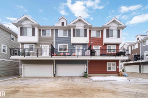 View of front of home featuring driveway, a balcony, and a garage - 31 2803 James Mowatt Trail, Edmonton, AB - Outdoor With Balcony With Facade