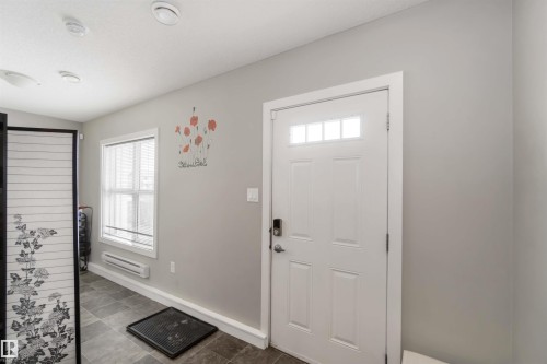 Entryway featuring healthy amount of natural light and baseboard heating - 31 2803 James Mowatt Trail, Edmonton, AB - Indoor Photo Showing Other Room