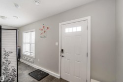 Entryway featuring healthy amount of natural light and baseboard heating - 