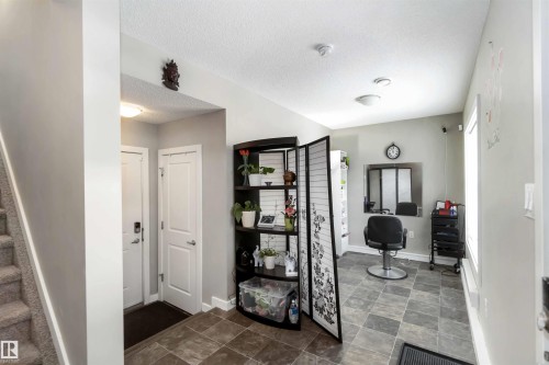 Full bathroom featuring a textured ceiling and stone finish flooring - 31 2803 James Mowatt Trail, Edmonton, AB - Indoor Photo Showing Other Room