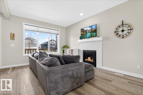 80 Maple Crescent, Gibbons, AB - Indoor Photo Showing Living Room With Fireplace