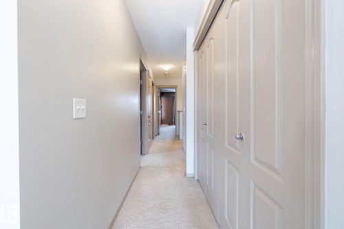 Hallway with light carpet and a textured ceiling - 3312 17B Avenue, Edmonton, AB - Indoor Photo Showing Other Room