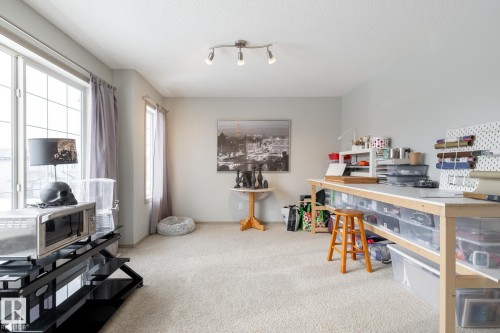 Office space featuring light colored carpet, a textured ceiling, and track lighting - 3312 17B Avenue, Edmonton, AB - Indoor