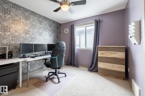 Office area with wallpapered walls, an accent wall, ceiling fan, light carpet, and a textured ceiling - 3312 17B Avenue, Edmonton, AB - Indoor Photo Showing Office