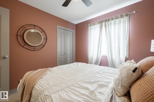 Carpeted bedroom featuring a ceiling fan and a closet - 3312 17B Avenue, Edmonton, AB - Indoor Photo Showing Bedroom
