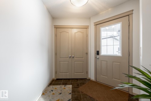 Doorway featuring tile patterned floors and baseboards - 3312 17B Avenue, Edmonton, AB - Indoor Photo Showing Other Room