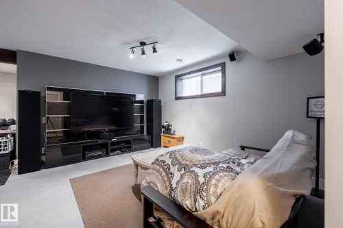 Bedroom with a textured ceiling and track lighting - 3312 17B Avenue, Edmonton, AB - Indoor Photo Showing Bedroom