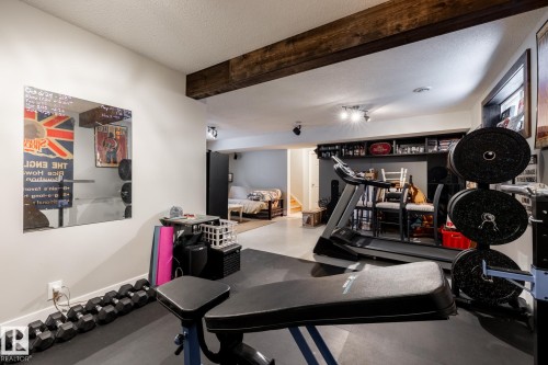 Workout area with a textured ceiling and beamed ceiling - 3312 17B Avenue, Edmonton, AB - Indoor Photo Showing Gym Room