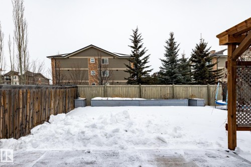 Yard covered in snow with a fenced backyard - 3312 17B Avenue, Edmonton, AB - Outdoor