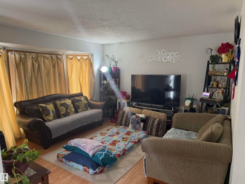 Living area with a textured ceiling and wood finished floors - 101 1 Aberdeen Way, Stony Plain, AB - Indoor Photo Showing Living Room