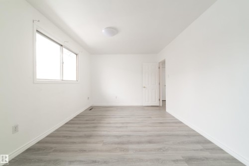 Empty room featuring light wood finished floors - 11430 81 Street, Edmonton, AB - Indoor Photo Showing Other Room