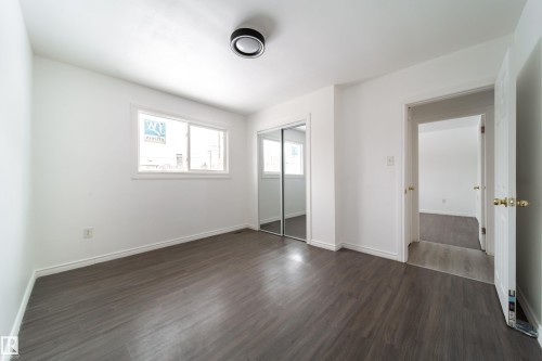 Unfurnished bedroom featuring dark wood-style floors and a closet - 11430 81 Street, Edmonton, AB - Indoor Photo Showing Other Room