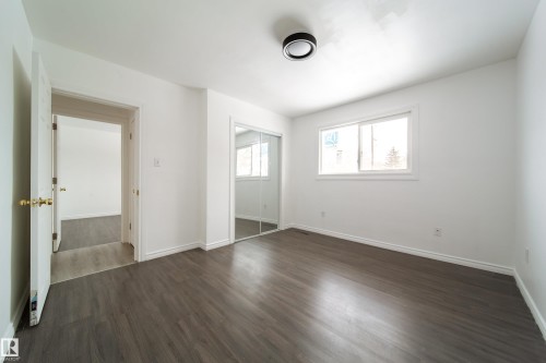 Unfurnished bedroom with dark wood-style flooring and a closet - 11430 81 Street, Edmonton, AB - Indoor Photo Showing Other Room