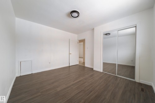 Unfurnished bedroom with dark wood finished floors and a closet - 11430 81 Street, Edmonton, AB - Indoor Photo Showing Other Room
