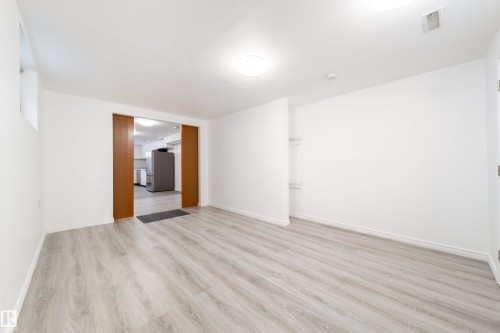 Spare room with light wood-style flooring and baseboards - 11430 81 Street, Edmonton, AB - Indoor Photo Showing Other Room