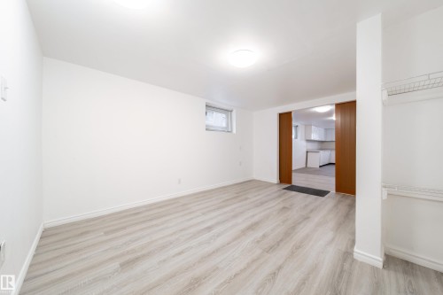 Basement featuring light wood-style floors and baseboards - 11430 81 Street, Edmonton, AB - Indoor Photo Showing Other Room