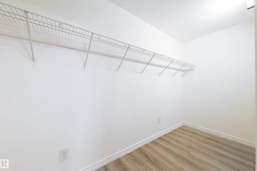 Walk in closet featuring light wood-style flooring - 11430 81 Street, Edmonton, AB - Indoor With Storage