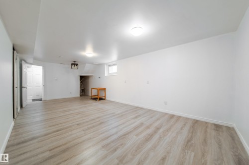 Basement with light wood-style flooring and baseboards - 11430 81 Street, Edmonton, AB - Indoor Photo Showing Other Room