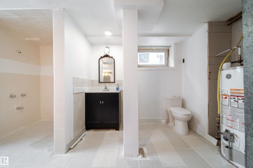 Full bathroom with vanity, water heater, a walk in shower, recessed lighting, and light tile patterned flooring - 11430 81 Street, Edmonton, AB - Indoor Photo Showing Bathroom