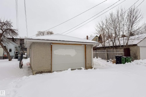 Snow covered garage featuring a garage - 11430 81 Street, Edmonton, AB - Outdoor