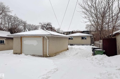 Snowy yard with an outdoor structure and a garage - 11430 81 Street, Edmonton, AB - Outdoor