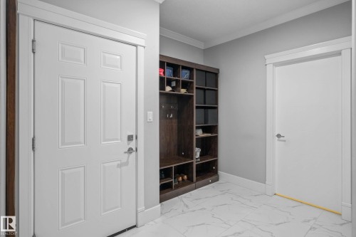 Mudroom with crown molding and light marble finish floors - 4086 Whispering River Drive, Edmonton, AB - Indoor Photo Showing Other Room